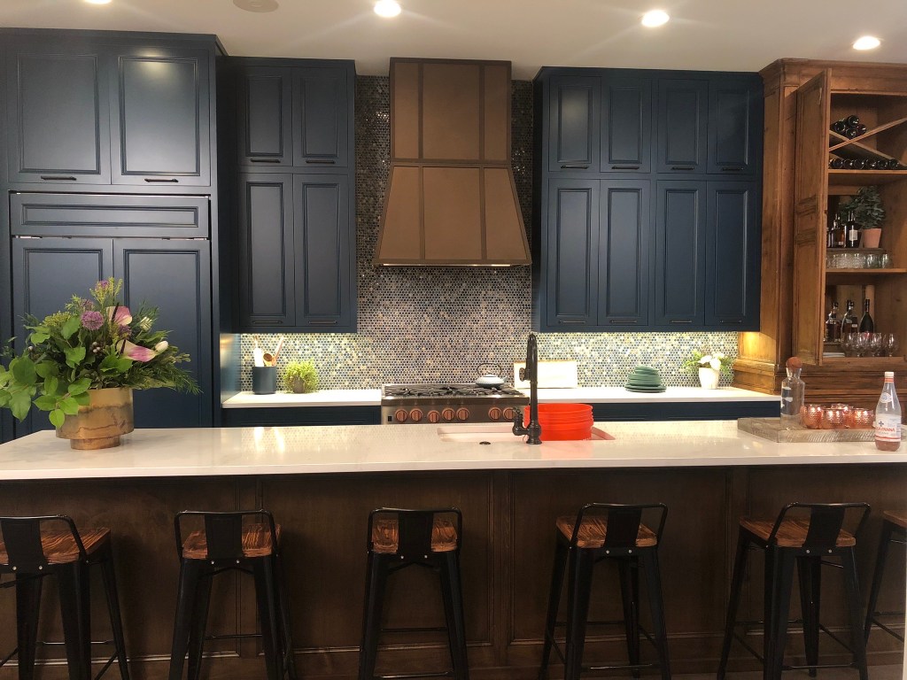 kitchen blue cabinets wood hutch quartz metal range hood wolf penny tile backsplash counter stools